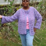 Attractive African-American woman modeling lacy purple crochet cardigan